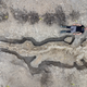 A paleontologist poses alongside the ichthyosaur skeleton found at Rutland Water.